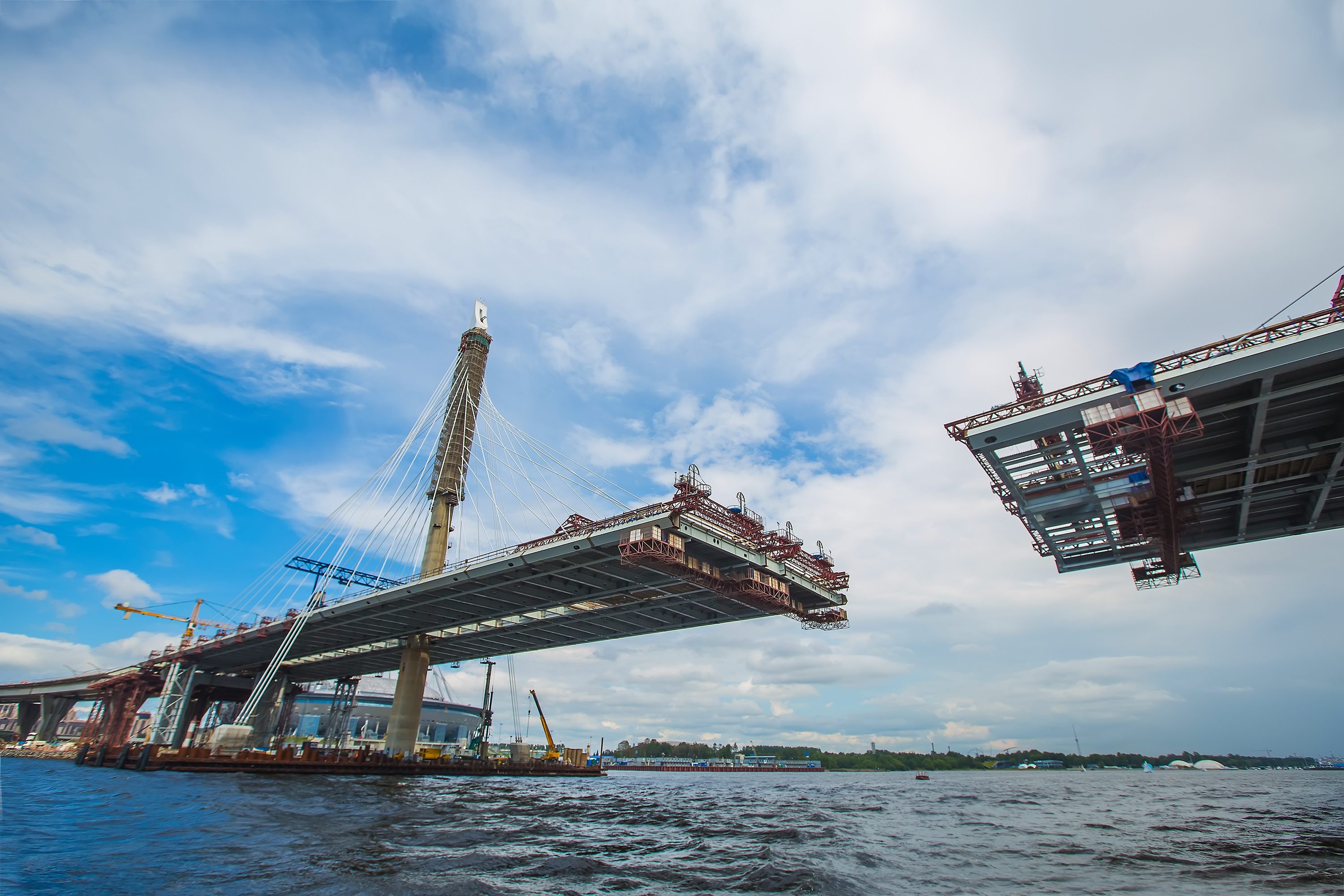 beautiful cable-stayed bridge in the construction process. summer. the view from the water