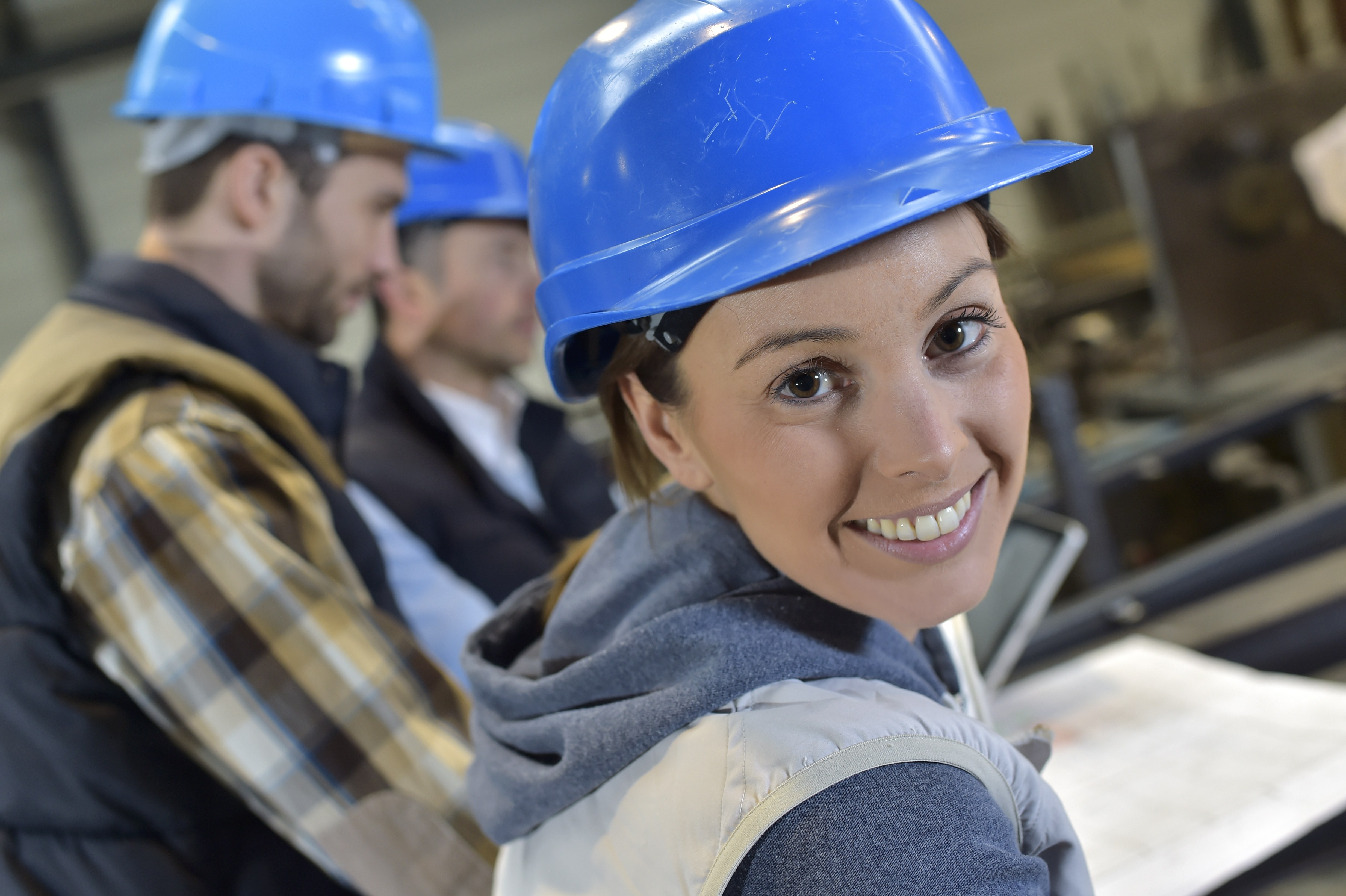 Cheerful woman industrial engineer at work